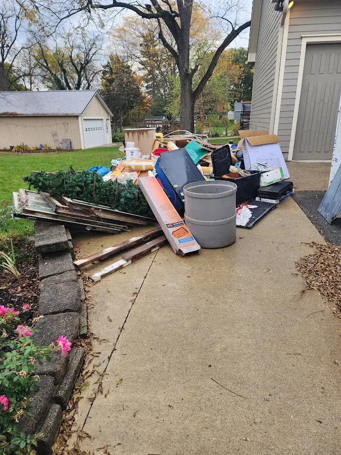 Dumpster being loaded with debris for Roofing Dumpster Rental in Turpin Hills